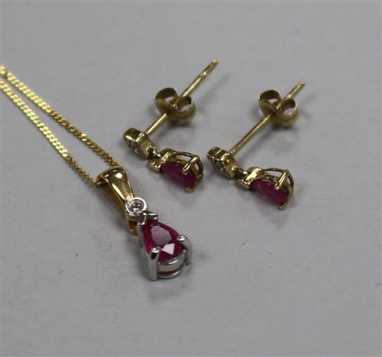 A modern 9ct gold, ruby and diamond set suite of jewellery, comprising pendant on chain and pair of drop earrings.